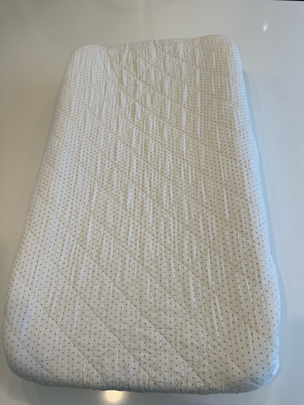 Pehr Pin Dot changing pad in a baby blue color
